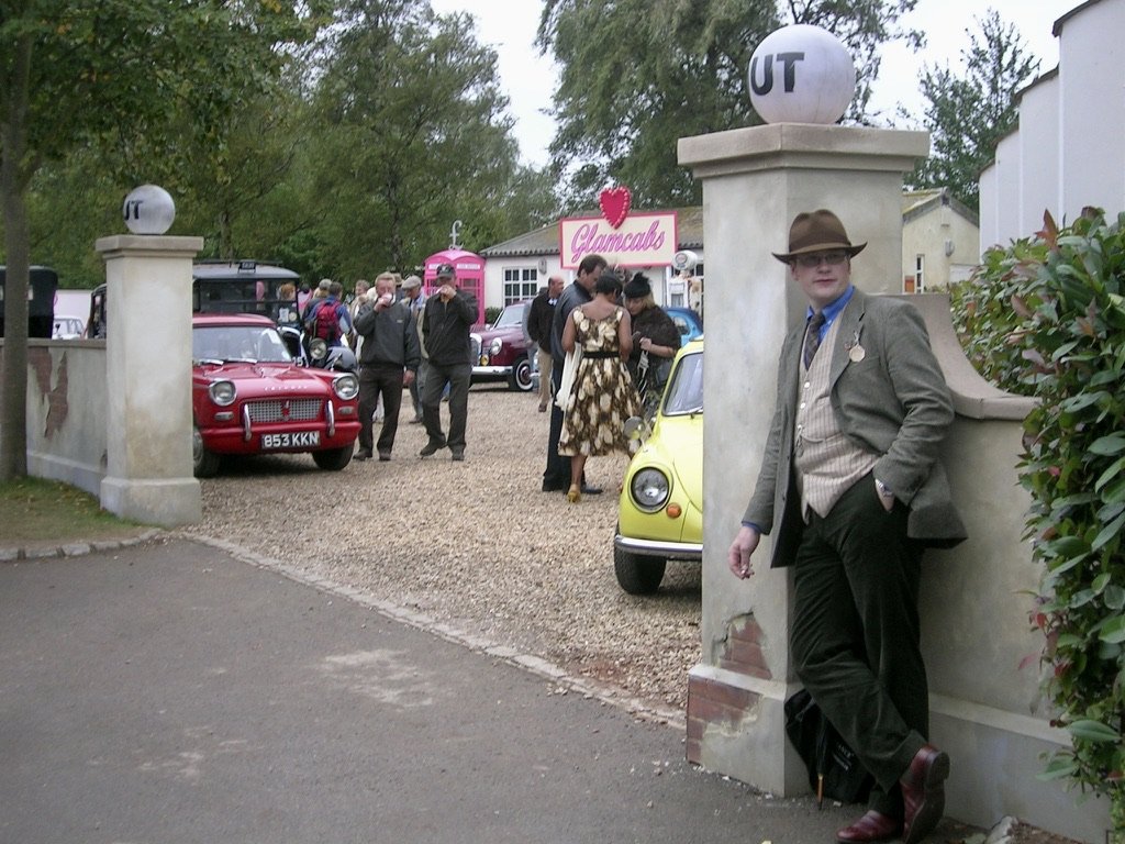 Goodwood Revival. Chicester, England.  Guests were encouraged to arrive in period appropriate dress. And, they had actors &amp; models in costume strolling the grounds of the Revival.