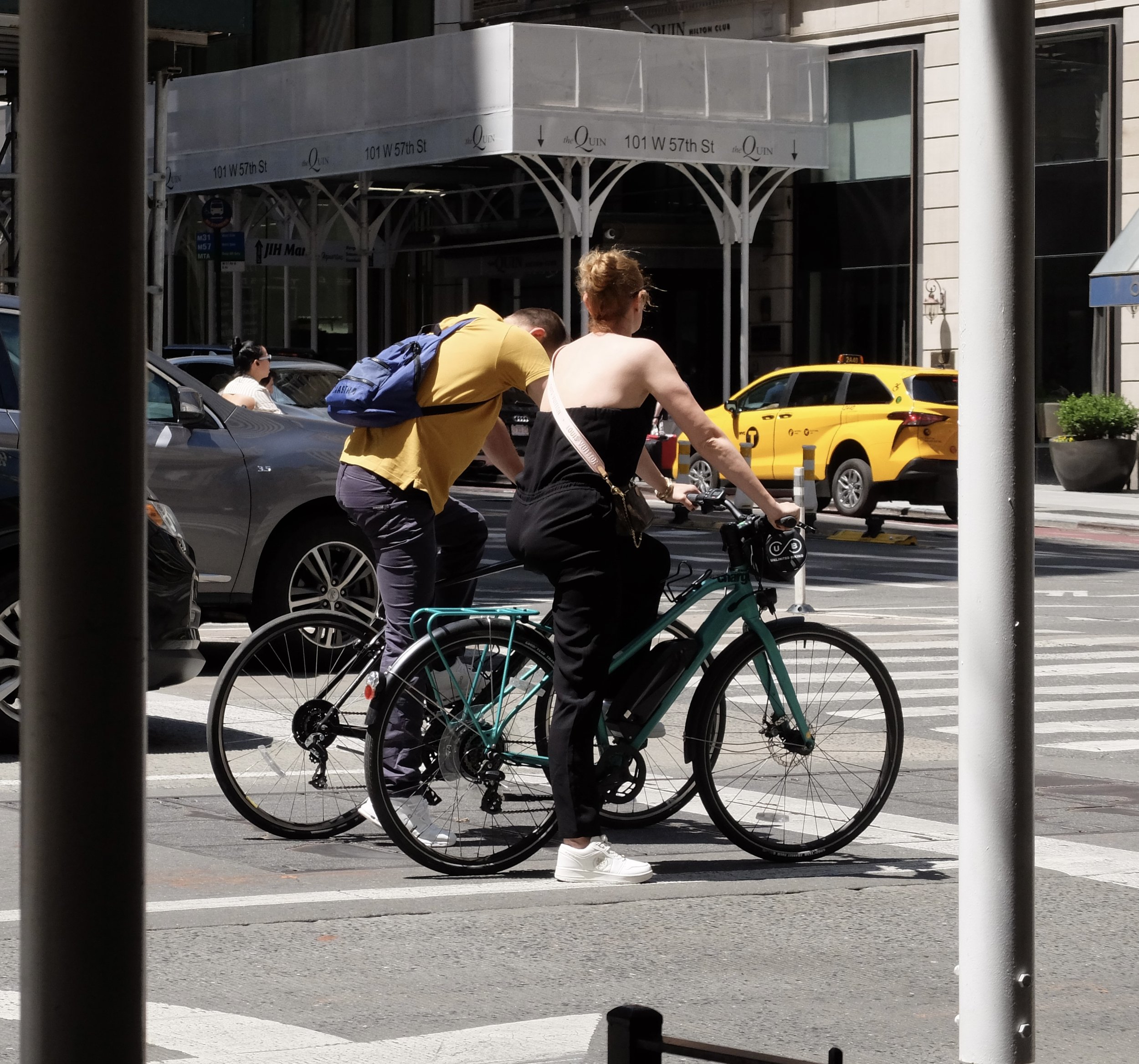  Based on their bicycles, these are locals, without helmets.  The bicycle rental places were disgorging many tourists, into the crowded area leading into Central Park.  Most of these riders had on no helmets &amp; appeared to be novices regarding rid