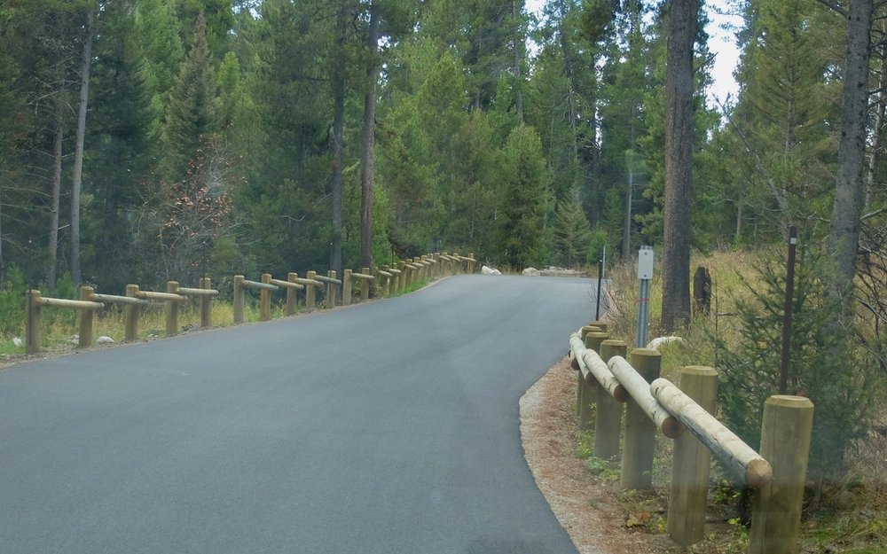  Driving the Moose-Wilson Road, an 8 mile scenic drive between Teton Village and Moose, WY.  The descriptions we had read about this drive noted that this section was a dirt road.  They had just paved it.  There were many road bike riders enjoying ri