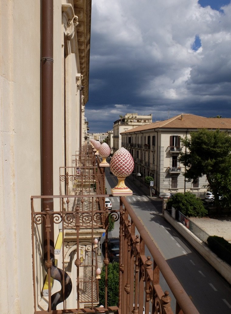  Grande Albergo Alfeo balcony view with ceramic pine cones; "ornaments that are a wish for health, good luck, and prosperity."