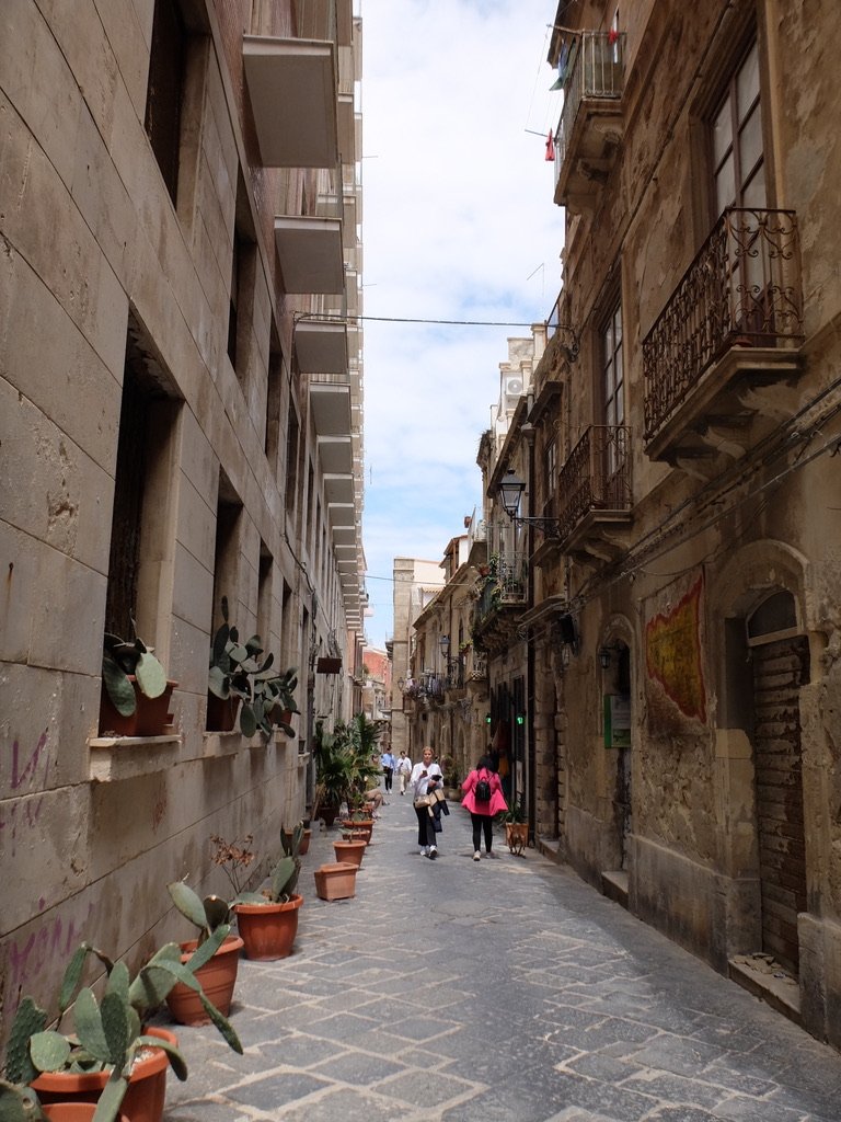  A common sighting in Siciiy, Mussolini fascist architecture on the left &amp; much older building across the alley. 