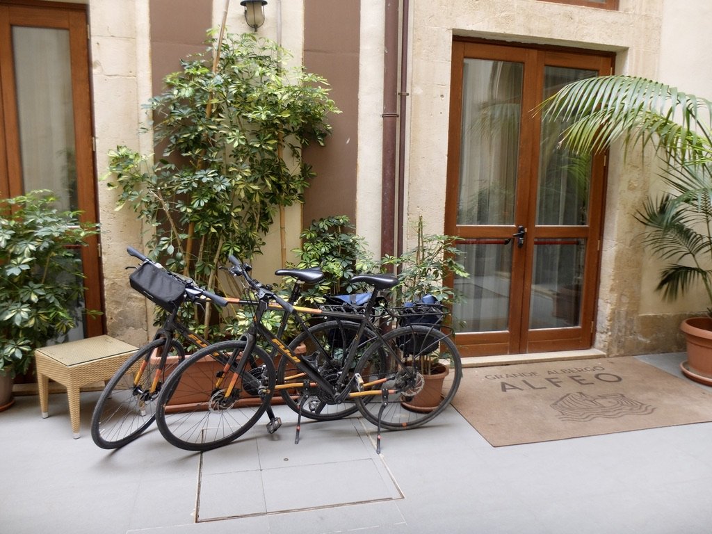  In the courtyrard of Grande Albergo ALFEO.  Bicycles of an English couple biking Sicilia.  At home they have an MGB, Jaguar E type &amp; are restoring a Triumph Stag .   