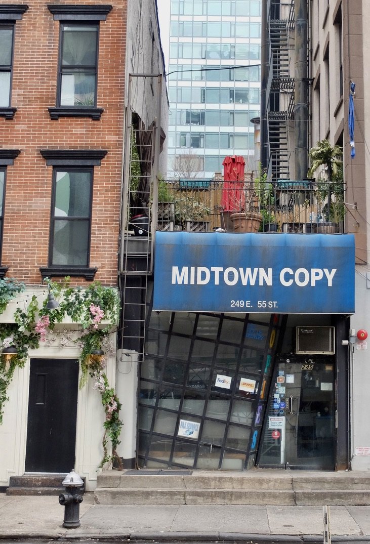 Down below, this store has been vacant &amp; unchanged for some time.  Perhaps it had something to do with it sharing the address with the building to the right.  Complicated zoning issues?