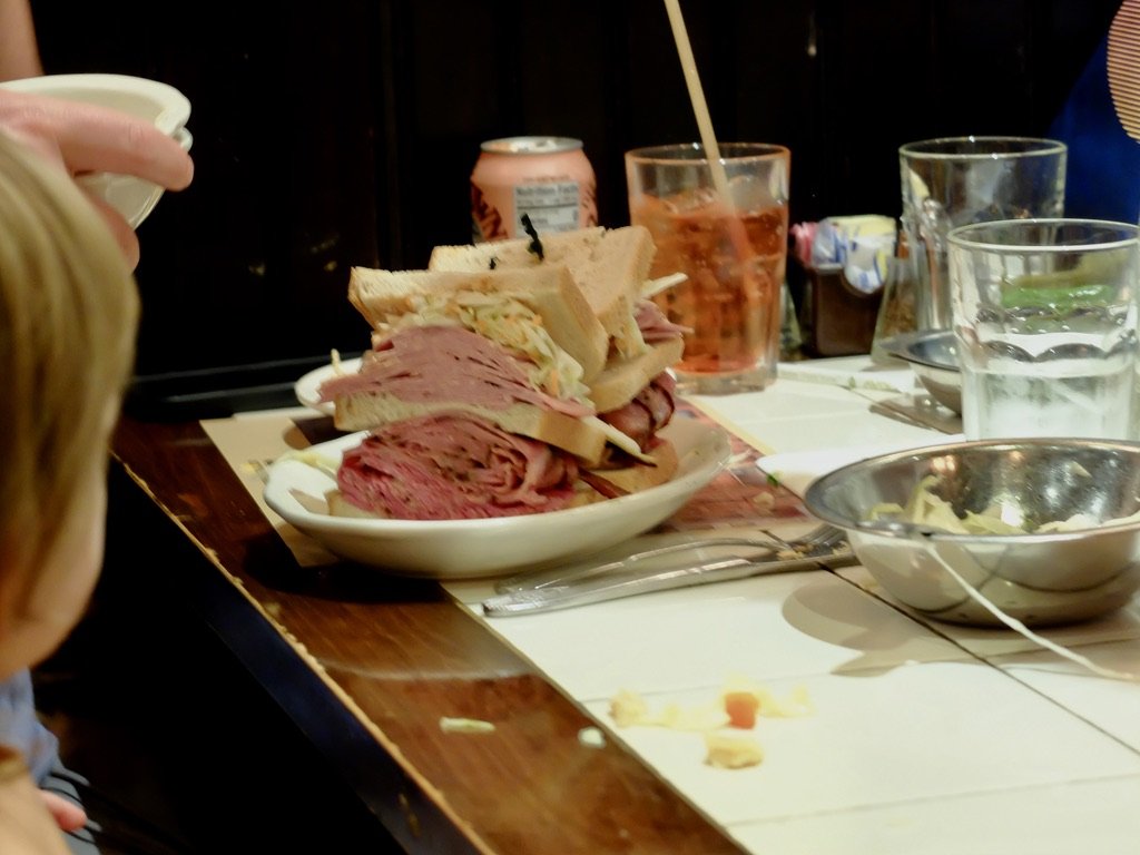  Across the aisle.  The dad finished it all, with a tiny bit of help from his wife.  2nd Ave. Deli. 