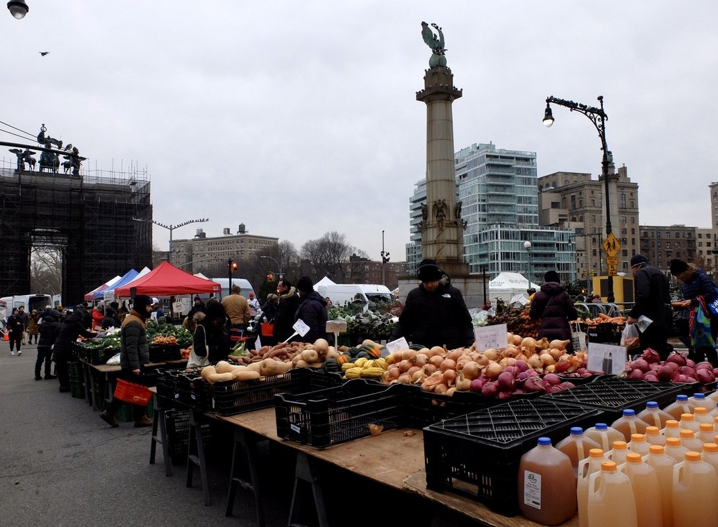  Grand Army Plaza Saturday farmers market.  “Grand Army Plaza, the majestic entrance to Prospect Park” is undergoing a $9 million restoration.  The c. 1867 arch is under wraps &amp; getting cleaned &amp; restored. 