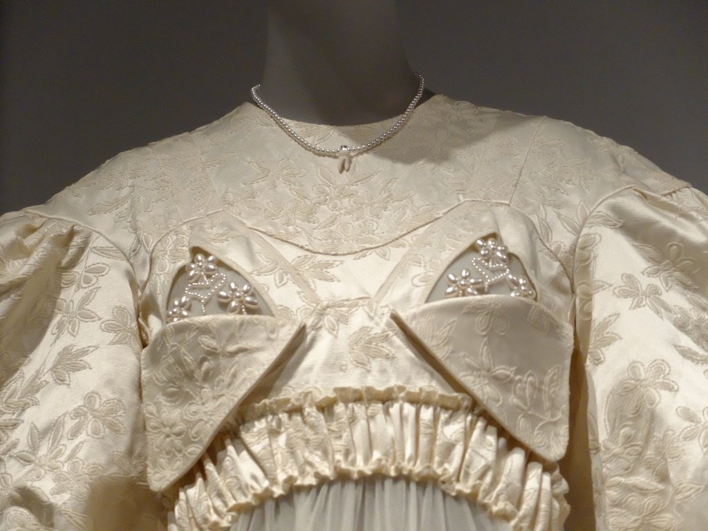   Women Dressing Women   @ the MET.  “…a mannequin that was dressed in a Spring 2023 Simone Rocha dress adorned with porcelain baby teeth and pearl-beaded breast pockets reminiscent of the cups of a nursing bra…  According to the gallery label, the p
