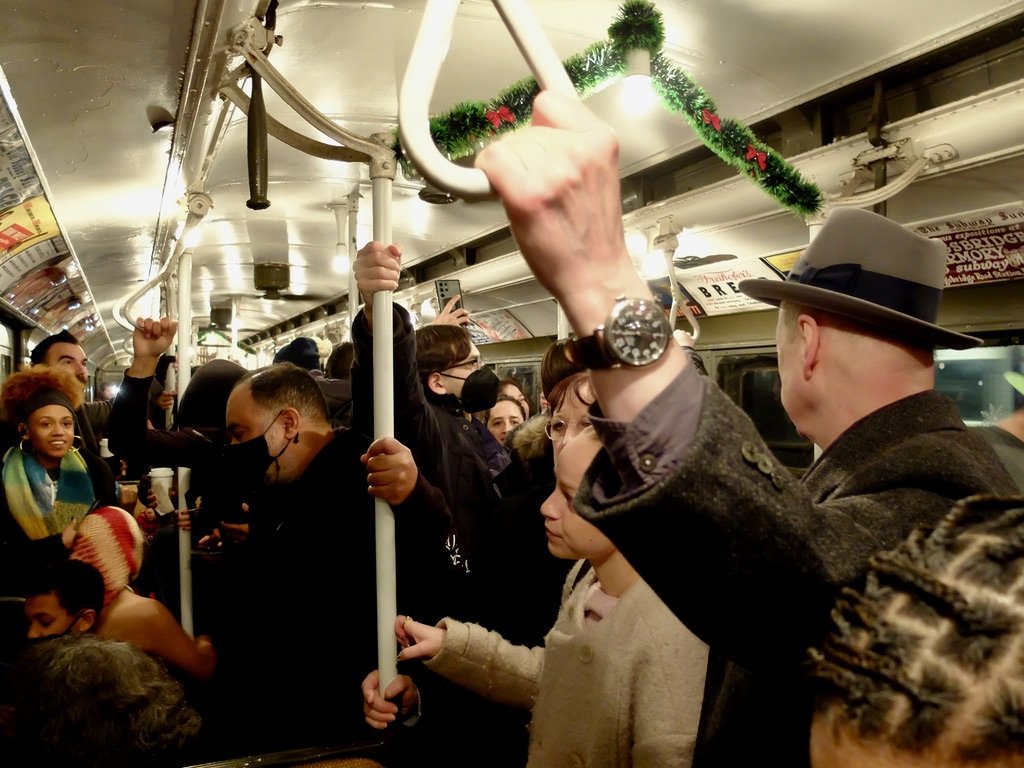  “The term ‘straphangers’ originated in the early 20th century when the NYC subway system was first introduced. At that time, the subway cars did indeed have straps hanging from the ceiling for people to hold onto while standing during their commute.