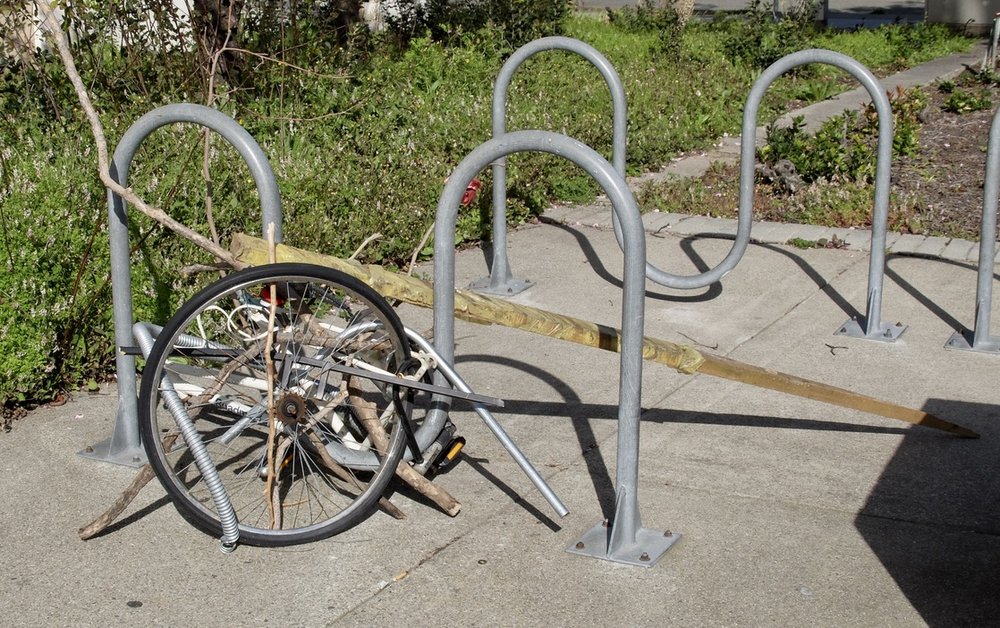  Maybe began as an abandoned bicycle wheel &amp; became an impromptu art installation? 