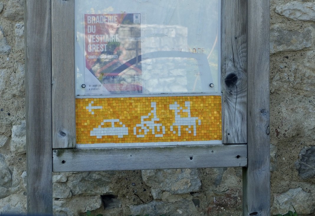  Corbonne, Drôme.  Mosaic instruction sign. Cars, bicycles &amp; horses to the left. 