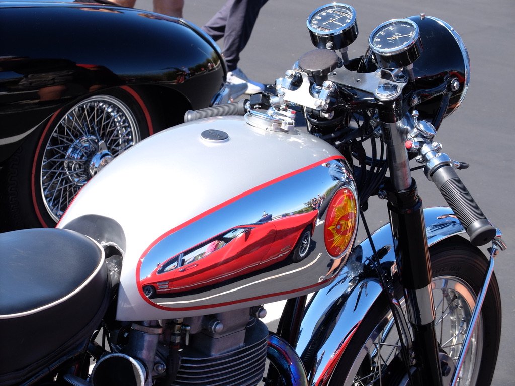 The red Capri, reflected in the BSA motorcycle, was in the British section. We thought it was American, made by Ford's Mercury division. But no, they were first made in Europe; this one in the U.K.