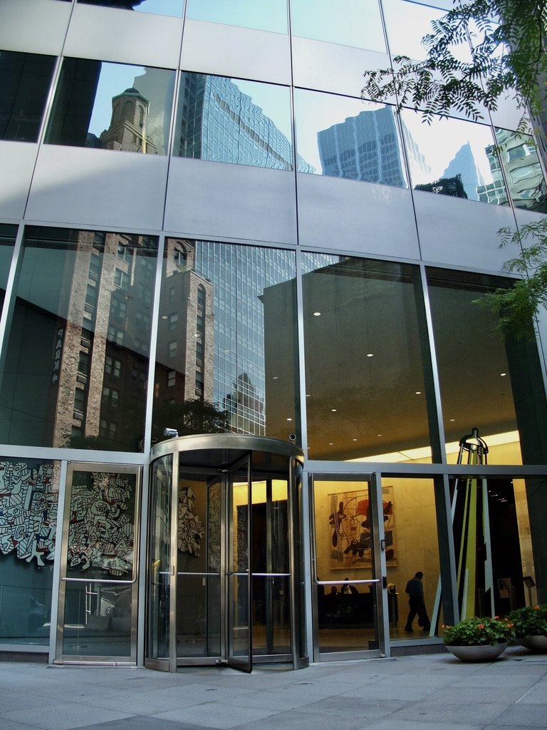 The guard would not allow me to photograph the artworks in the Madison Tower lobby. I did so outside & caught the Hotel Elysée reflection in the windows.