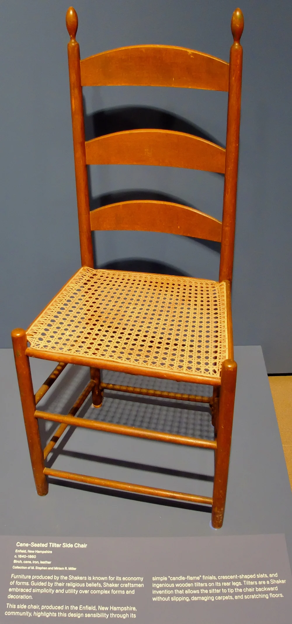 “Cane-Seated Tilter Side Chair   c. 1840-1860  Birch, cane, Iron, leather  Furniture produced by the Shakers is known for its economy of forms. Guided by their religious beliefs, Shaker craftsmen embraced simplicity and utility over complex forms an