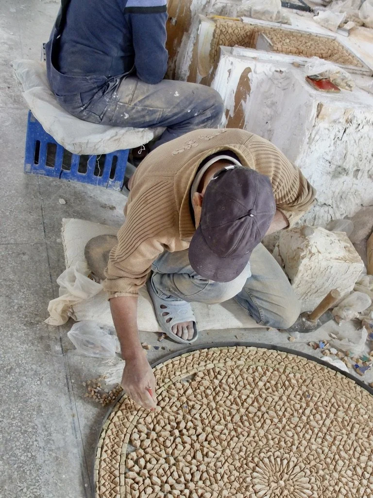  Ain Nokbi.  This will be a table.  He’s working upside down &amp; knows the colors of all the tiles as he places them before fiberglass is poured.  Cement is no longer used.  Much too heavy. 
