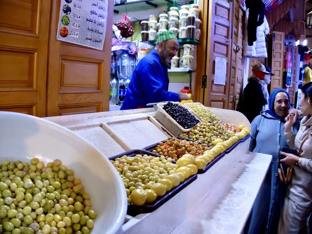 Happy people at a stall in the food souk of the Meknes medina.