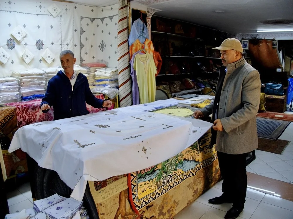  ...that sold amazingly embroidered cotton.  The man on the left was an artisan trained in a… 