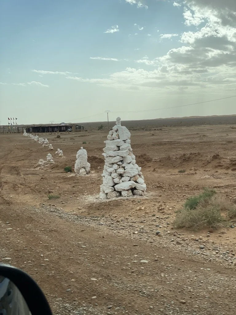 Andy Goldsworthy style rock piles leading to camel rides.