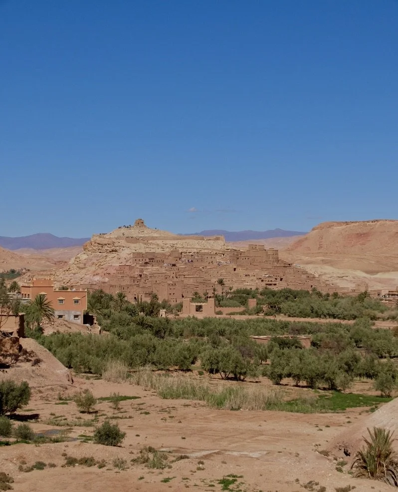  The&nbsp;origins&nbsp;of Ait Benhaddou can be traced back to at least the 11th century. It "… is a historic ighrem or ksar along the former caravan route between the Sahara and Marrakesh... It is considered a great example of Moroccan earthen clay a