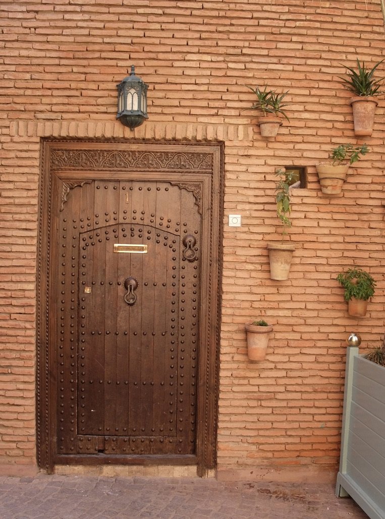  The two-in-one door. The middle knocker is for friends &amp; family &amp; the small, middle door will be opened for their entrance.  The upper right hand knocker is for tradespeople.  The larger door opening allows the ingress of large items. 