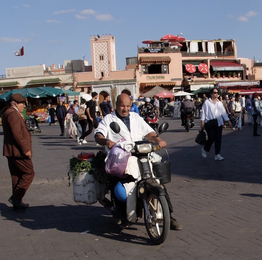  The red  umbrellas atop the building are where we had dinner.  Jemaa el-Fnaa Square. 