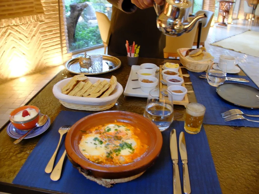  BERBER OMELETTE Merguez sausages - eggs - tomato - fried in a tagine - Tanoort bread.  And, homemade Moroccan pastries with jams, amlou, honey &amp; olive oil.  The amlou consists of argan oil, almonds &amp; honey.  We had it at many meals in differ