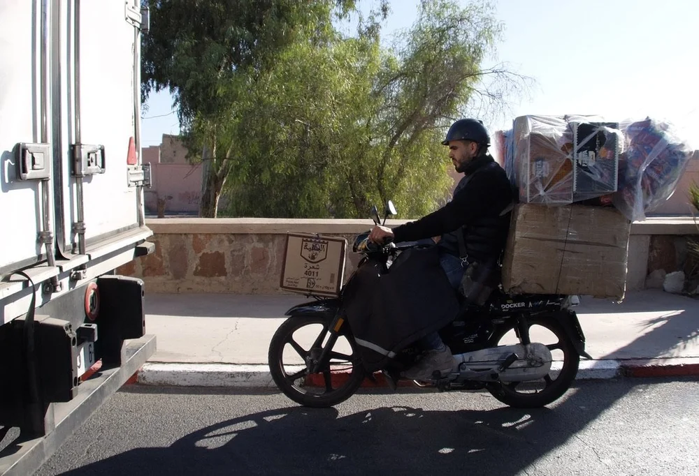  "Escape the ordinary with these crispy bugles available in four magical flavours: Ketchup, Chilli, Ch... Que Rico! It tastes like Mexico!"  As read on the packages he was carrying. 