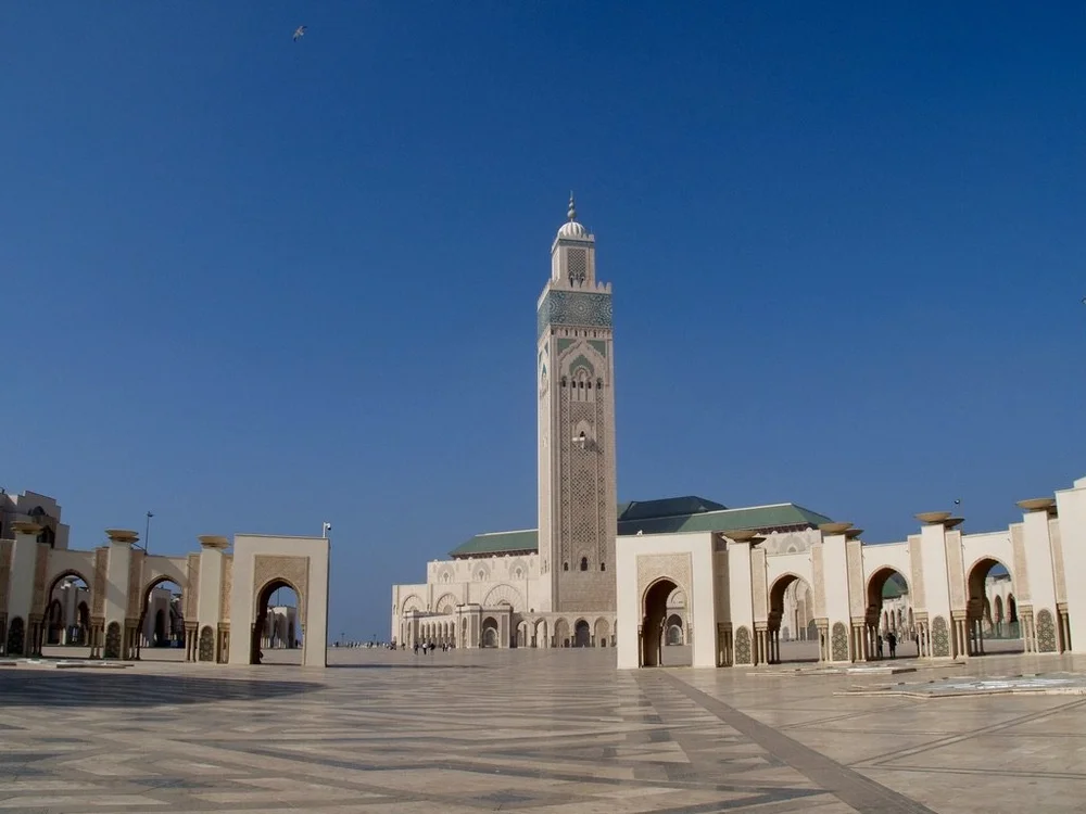    The c. 1933  “ Hassan II Mosque ( Arabic : مسجد الحسن الثاني)is…the second largest functioning mosque in Africa and is the  14th largest  in the world.”  Being built “on the Atlantic Ocean is inspired by the Qur'anic verse 'the throne of God was u