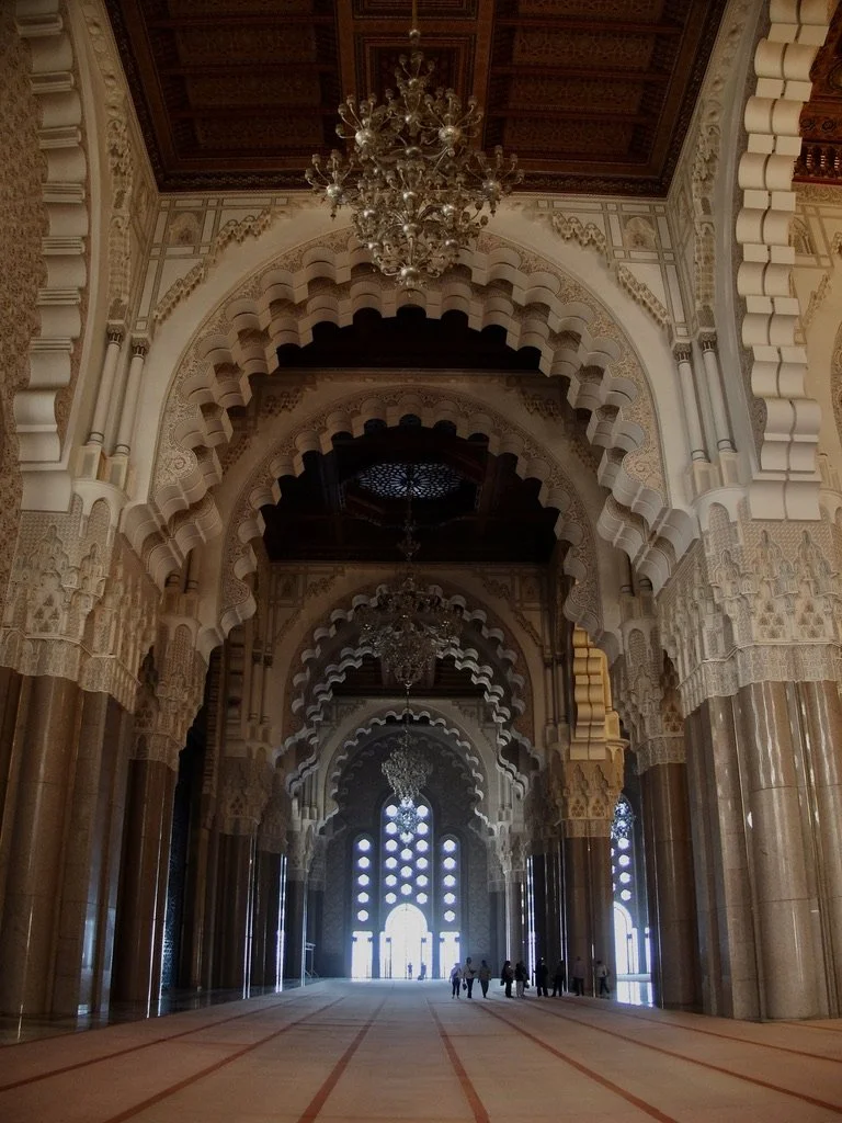  “The walls are of hand-crafted marble and the roof is retractable. A maximum of 105,000 worshippers can gather together for prayer: 25,000 inside the mosque hall and another 80,000 on the mosque's outside ground.” 