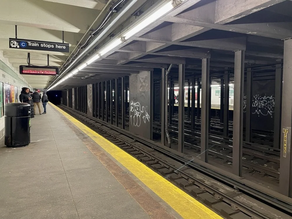  On the left, down the platform, three policemen were citing a fellow for evading a fare by jumping a turnstyle.  To paint that graffiti the perpetrators had to deal with the highly electrically charged third rail right below their work. 