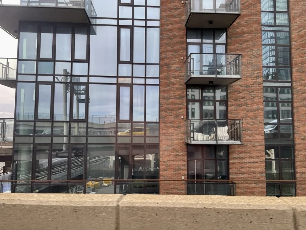  Our cab reflected in a window.    The balcony furniture to the right made me wonder who would want to sit out there? 
