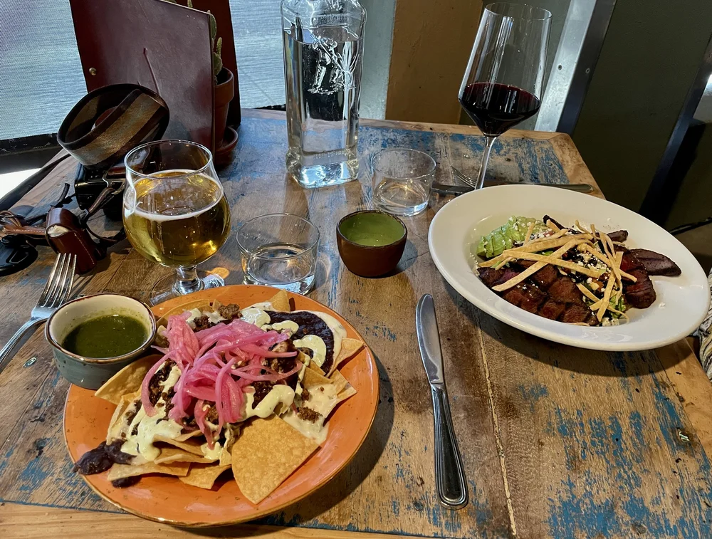  FISH GAUCHO Happy Hour special - OAXACA FLOCKA NACHOS Half Order corn chips, Snake River Farms wagyu ground beef, Oaxaca queso blanco, refried black beans, pico de gallo, avocado crema, pickled onions. 