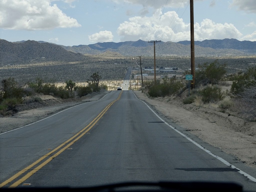 CA-247 N/Old Woman Springs Rd in Yucca Valley approaching Buena VIsta Drive. I don't think I'd feel safe bicycling up or down this road. In the distance, the San Bernadino Mountains in JTNP.