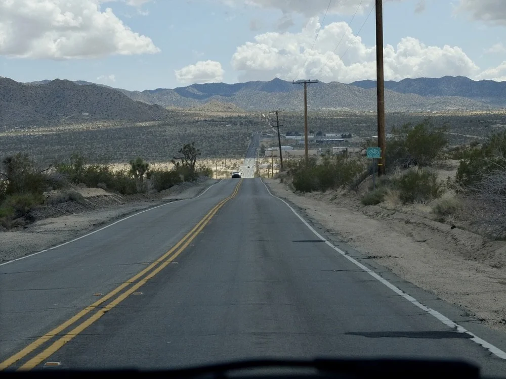  CA-247 N/Old Woman Springs Rd in Yucca Valley approaching Buena VIsta Drive. I don't think I'd feel safe bicycling up or down this road.  In the distance, the San Bernadino Mountains in JTNP.     