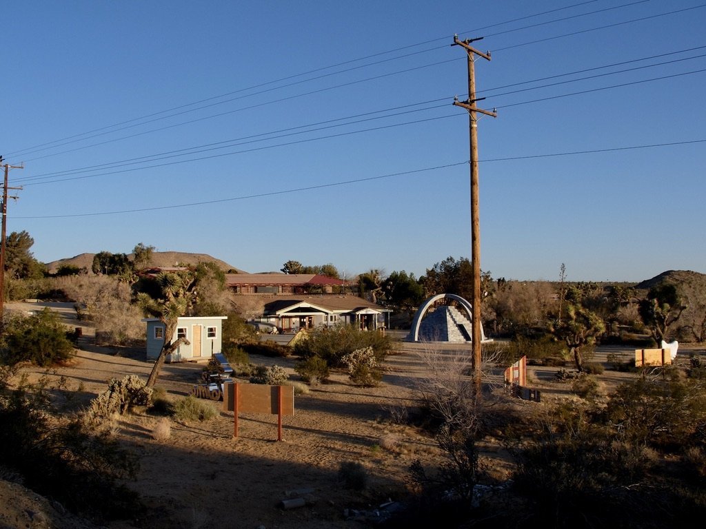 Joshua Tree Retreat Center – Institute of Mentalphysics. The building in the center is the Ding Le Mei House. Above it is the Caravansary building. Both were designed by Lloyd Wright. Frank Lloyd Wright was given the project but passed it along to
