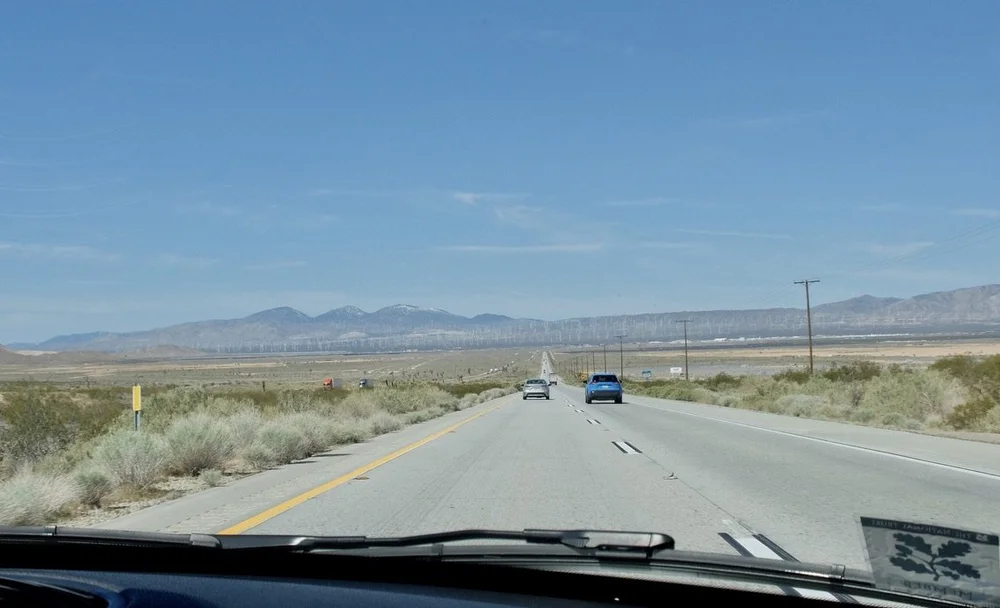  Wow, that’s a lot of wind turbines up ahead.  “For over 30 years, the mountains and foothills surrounding Mojave are home to wind farms generating electricity for Southern California. Known as the Tehachapi-Mojave Wind Resource Area, the area is con