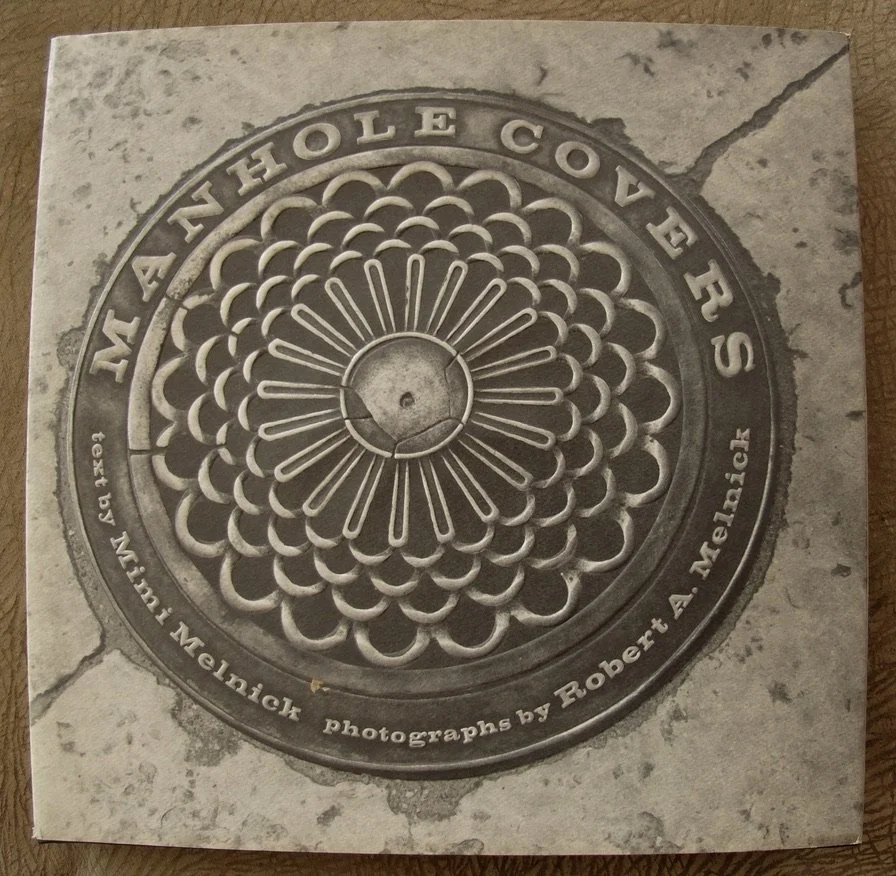 Naomi’s cousins Mimi & Robert Melnick published this book in 1996. We did not find out about it & get a copy of the book until I was well into noticing & photographing manhole covers. They started in the 1970’s when they were looking f