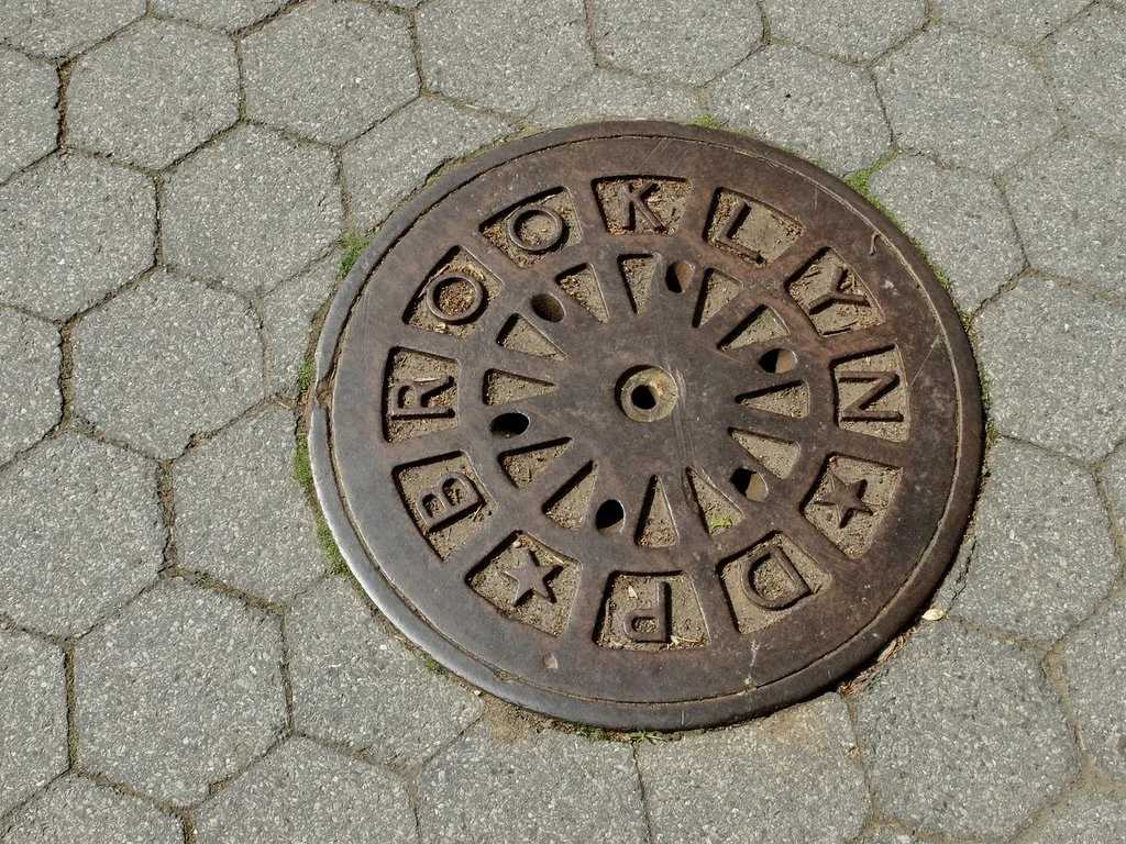 Looking down in Brooklyn one can spot some really vintage locally made examples. This one is on the walkway of the Brooklyn Bridge Park. “While the decorative qualities of manhole covers hold great appeal, the original purpose of the surface desi