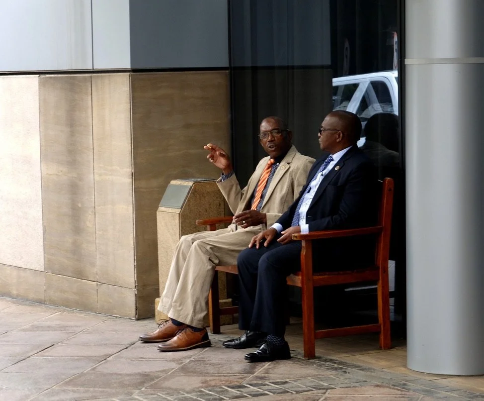  There were many men wearing suits &amp; ties around O.R. Tambo Airport in Johannesburg (Joburg), S. Africa. (ZA). The country code SA was already taken by Saudi Arabia. 