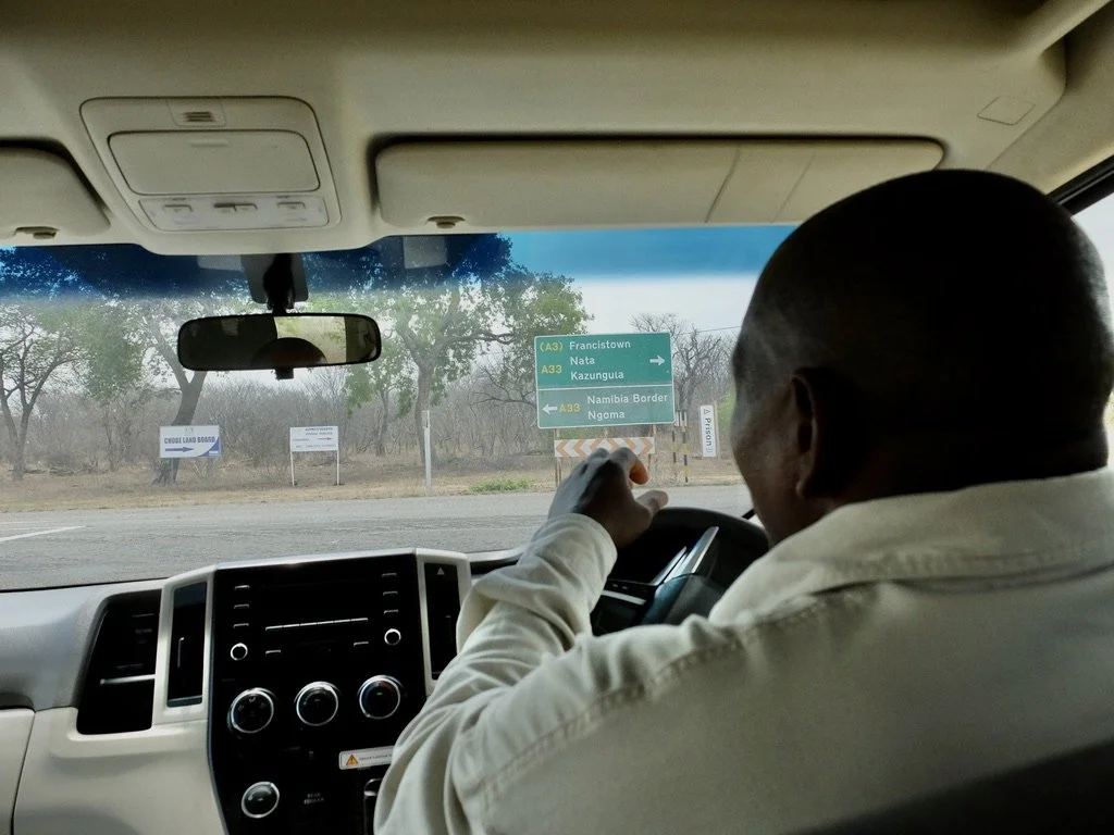  Our driver taking us to Muchenje Safari Lodge, Chobi River, Kasane, Botswana.  As mentioned in  A Carrion Death ,  Ngoma (entrance to Chobi Nat’l Park). 