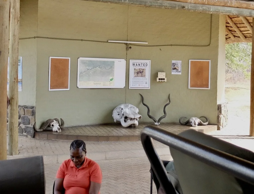  Note the sign about wild dogs.  We had a fleeting view of wild dogs here in Chobi but saw many at Notten’s Bush Camp, ZA.  Ngoma entrance to Chobi Nat'l Park &amp; Chobi River Front,  Kasane, Botswana. 