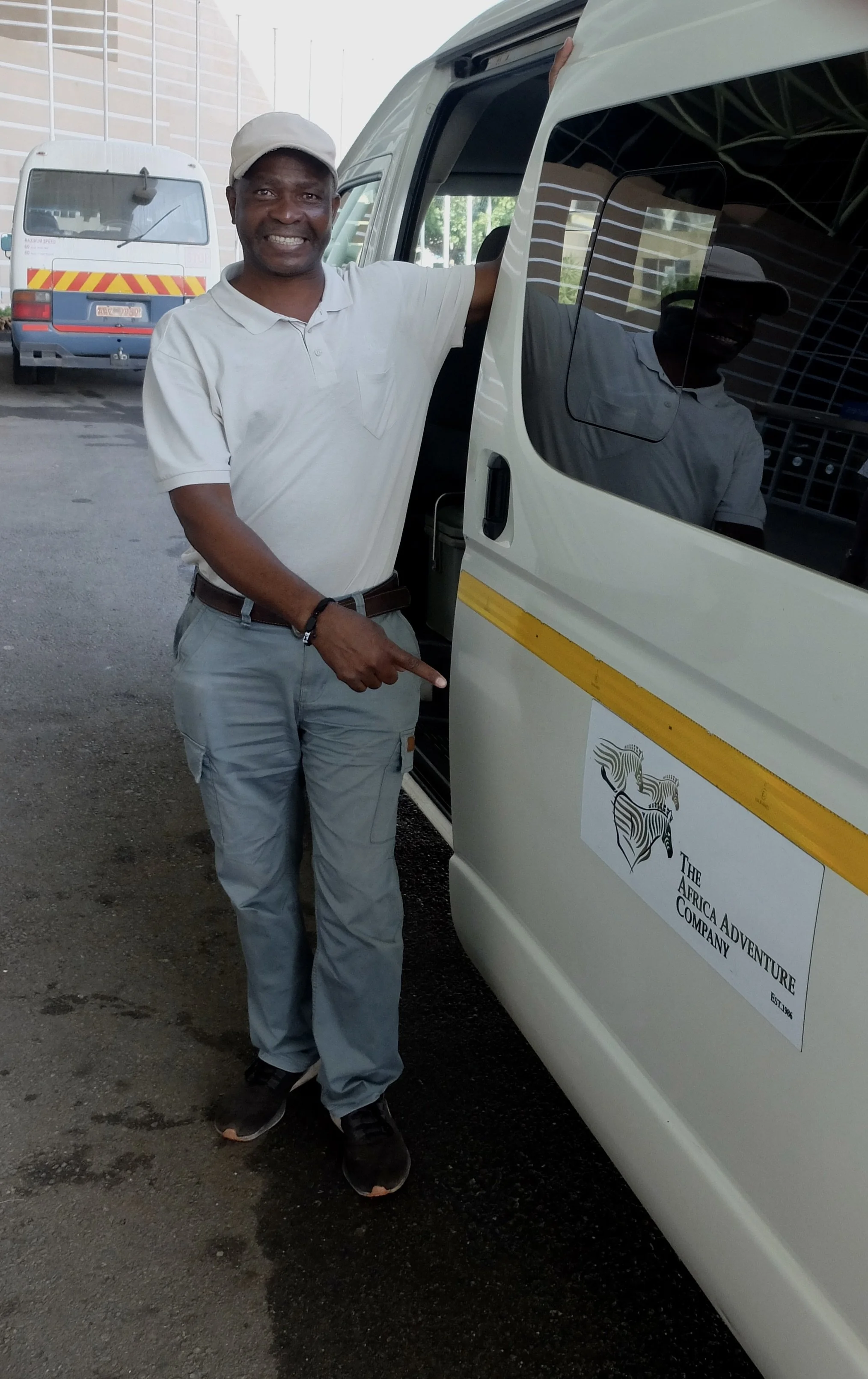  Our driver who was proud to work for The Africa Adventure Co.  He drove us all around the Victoria Falls area &amp; was the person who worked on his farm on his days off. 