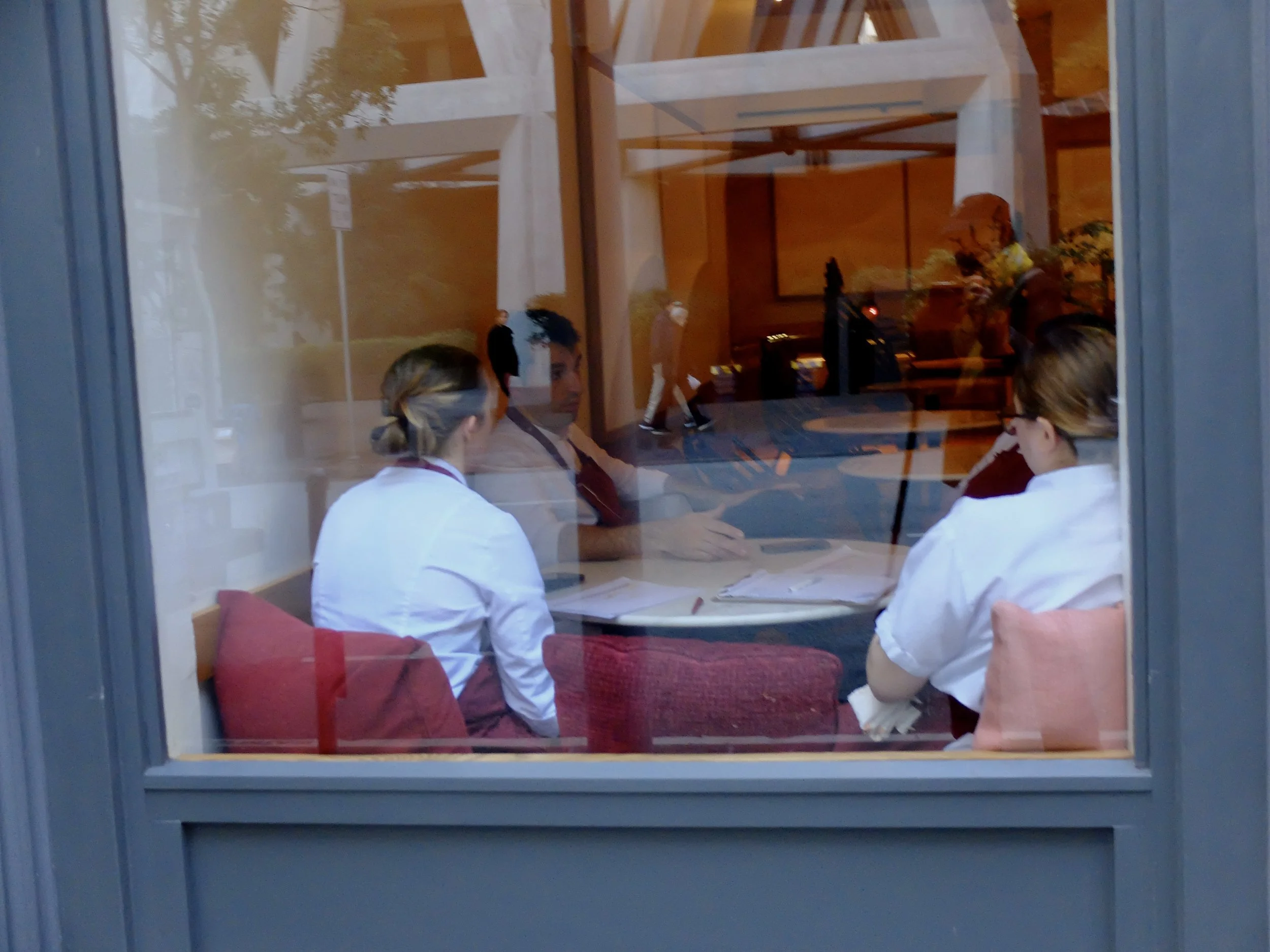 Before lunch is served, restaurant worker's huddle.