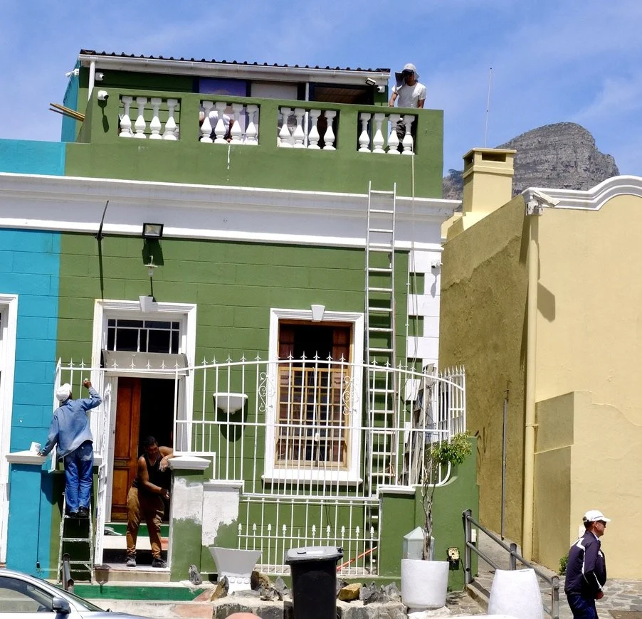  Workers freshening up a probably 1850’s building in “the Bo-Kaap (‘above the Cape’ in  Afrikaans) is an a rea of  Cape Town, South A  frica formerly kn own as the Malay Quarter.”  Cape Town Eats Tour with Karen Schmidt.  