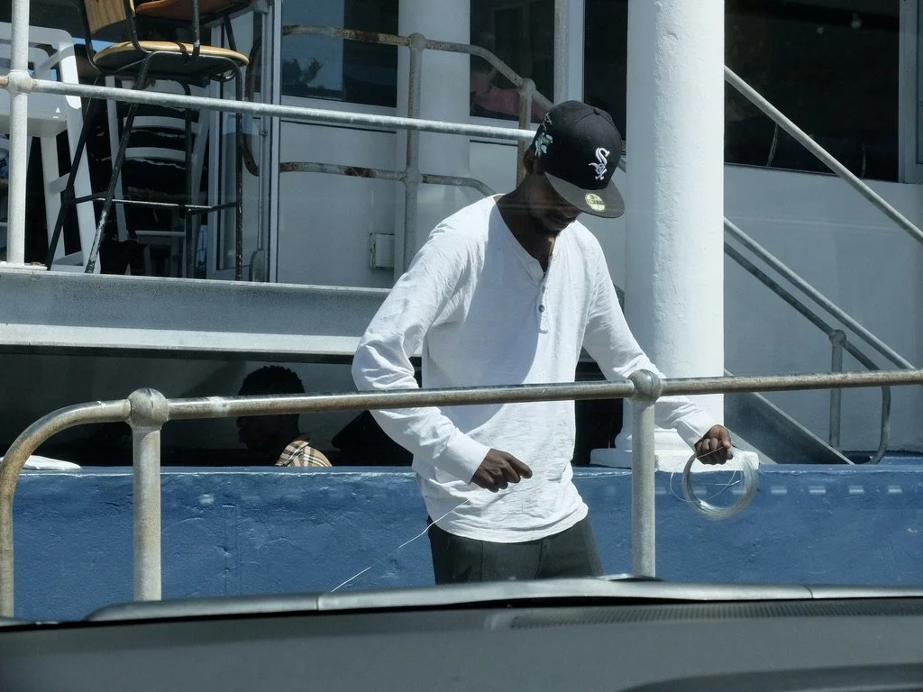  He’s preparing the wire for others to use in the souvenirs they were creating.  See previous photo.  Kalk Bay, South Africa. 