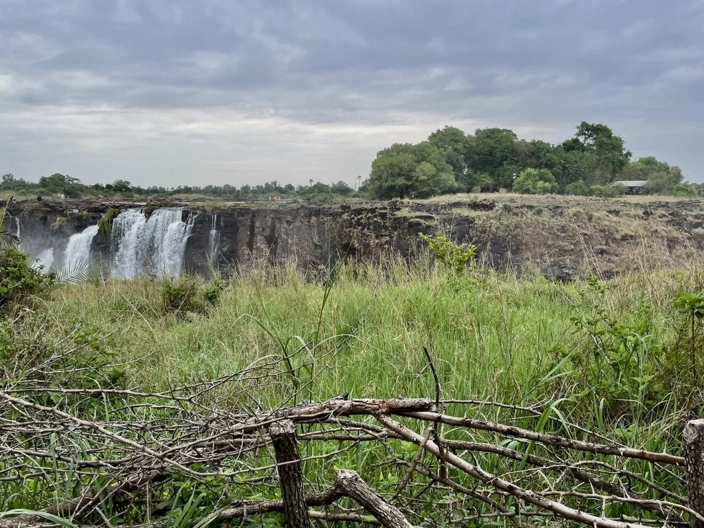  You can see folks walking to &amp; then further to the left, in the Devil’s Pool.   Victoria Falls Nat'l Park RAINFOREST a UNESCO World Heritage Site, Zimbabwe. 