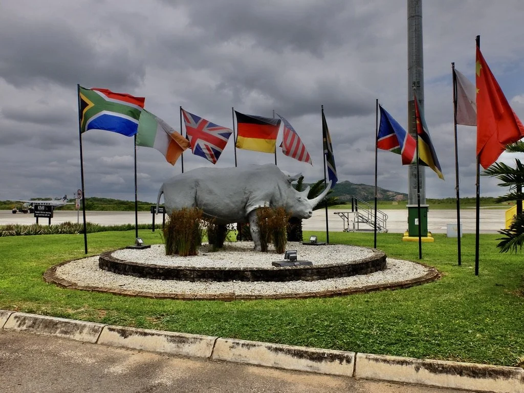  Poachers haven’t gotten to the tusks of this rhino at the Kruger Mpumalanga Internat'l Airport.  Our Federal Air flight was awaiting us.  It’s in the left of the photo or… 