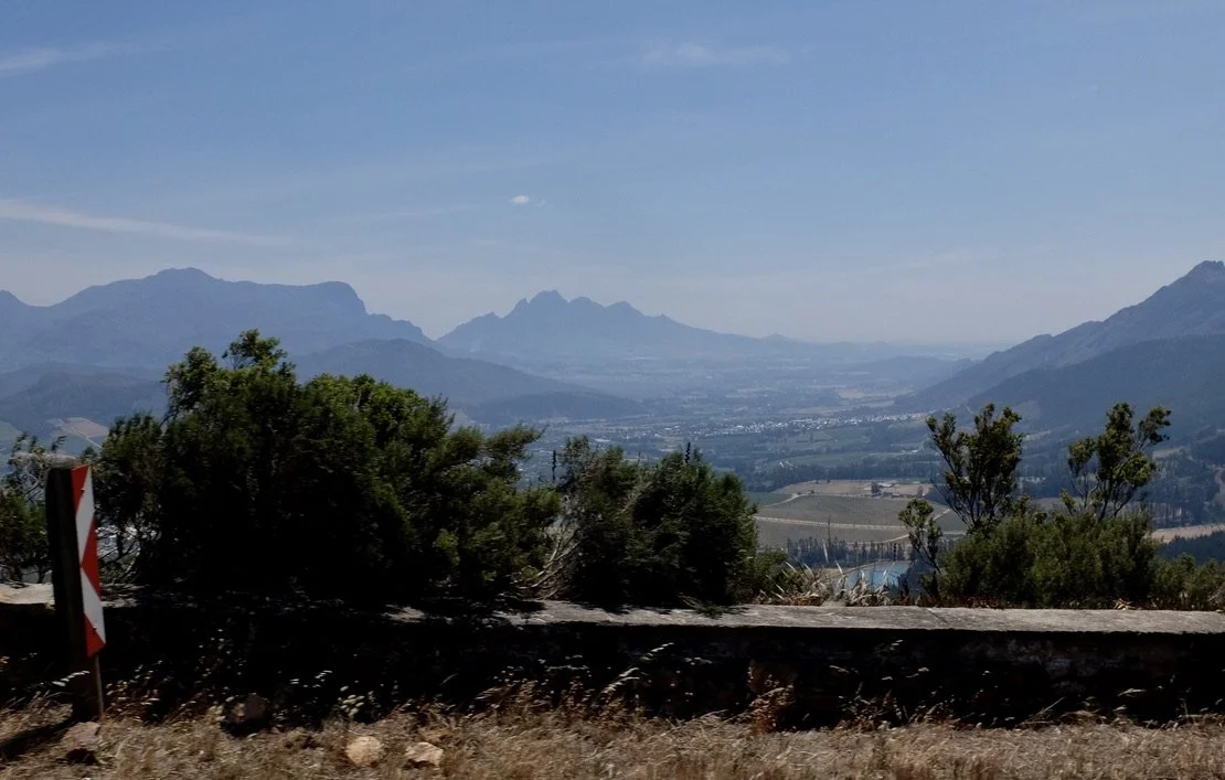  Seen from descending the pass, Franschhoek,  Afrikaans  for "French Corner" “…is one of the oldest towns in South Africa. It was formerly known as  Oliphants hoek (as there were vast groups of elephants roaming the  valley).”   
