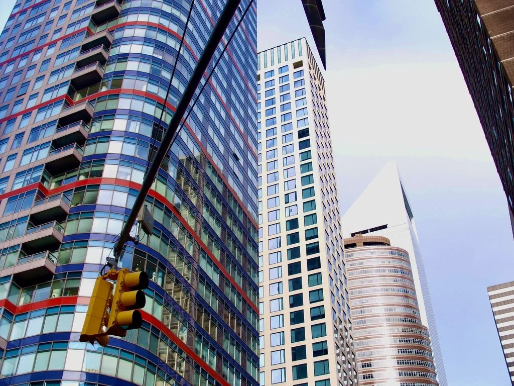  Photographing Manhattan skyscrapers can become banal.  For my 1st photography course at NYU I took what I thought was a most interesting view of the Statue of Liberty.  The professor simply said, “Tourist photo”. How to make it interesting?  Colors…