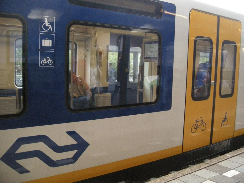  Blue &amp; yellow again.  This was our car.  Four of us were going to board with our fully loaded bicycles.  Off to Leiden.  Delft, Holland. 