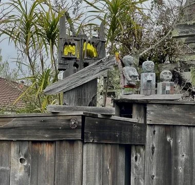  With neat wooden sculptures on the fence. 