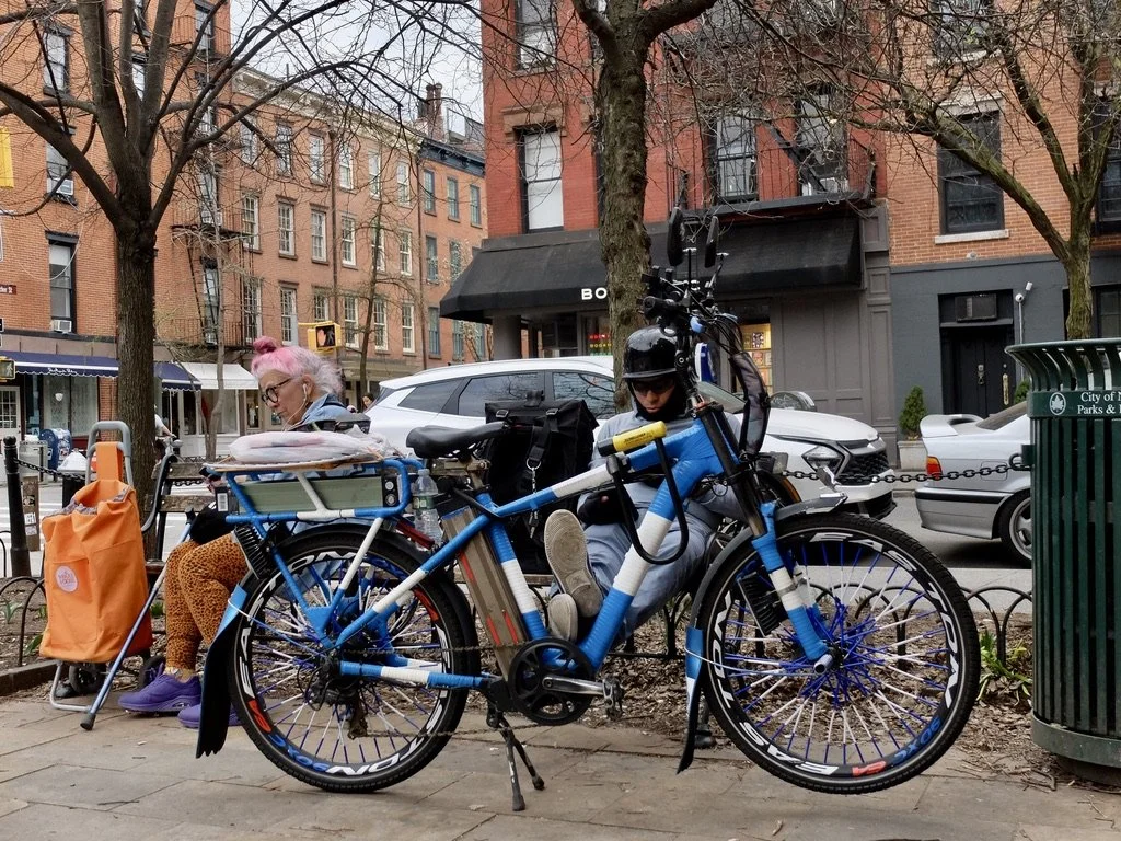  Sharing a bench in the West Village.  These bicycle messengers have no idea that their helmets mimic the WW II Nazi army's helmets. 